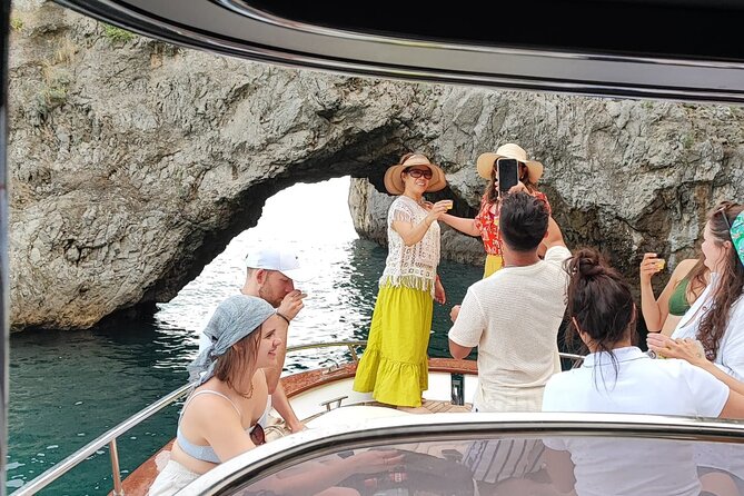 Capri and Blue Grotto Small Group Boat Tour - Spiaggia Grande and Bagni di Tiberio: Capri’s coastline with Roman context