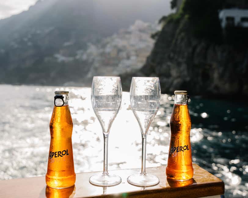 From Positano: Amalfi Coast Sunset Cruise - Group Tour - Meeting point on Spiaggia Grande: Positano Boats under the blue and white gazebo