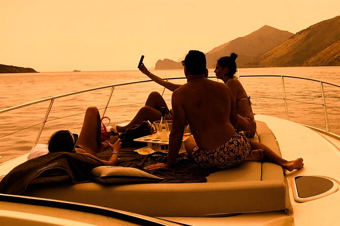 Small Group Tour to Positano by Boat at Sunset - Sunset on the Amalfi Coast, framed by Li Galli islets